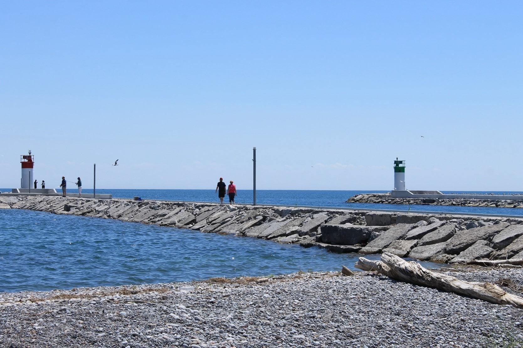 People walking on a pier along the waterfront trail in Pickering, Ontario, Canada